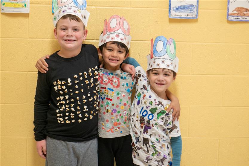 three boys smiling in 100 days smarter hats